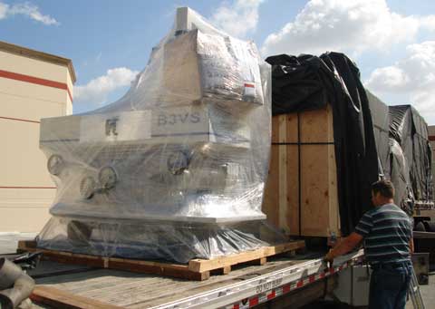 Photo shows a machine on a flat bed truck